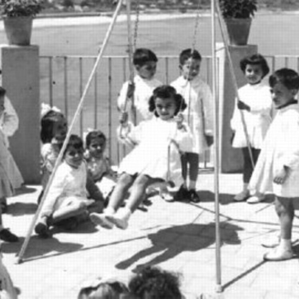 Antique photo of the Collegio di Maria di Cefalù terrace and swing with the children